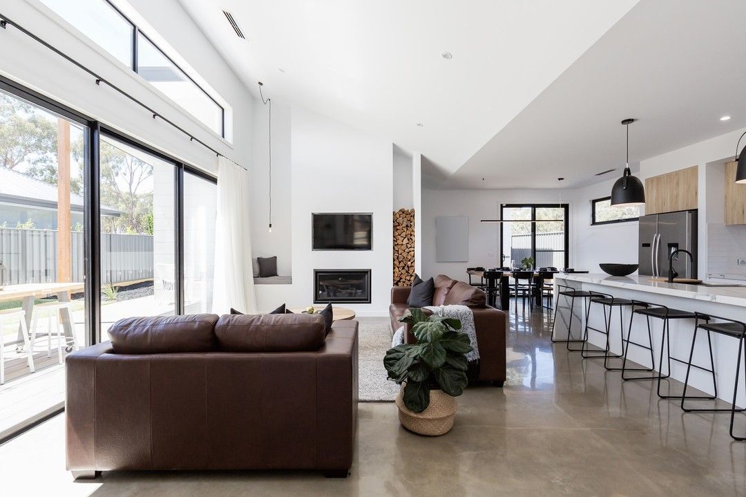 A Living Room With a Brown Couch and a Plant in It — Evoke Building Group In Ballarat Central, VIC