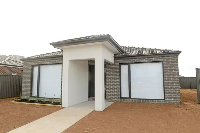 A Small Brick House With a Walkway Leading to It — Evoke Building Group In Bendigo, VIC