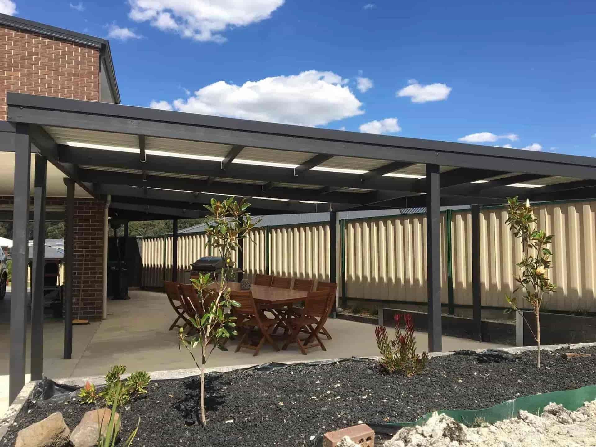 A Patio With a Table and Chairs Under a Pergola — Evoke Building Group In Daylesford, VIC