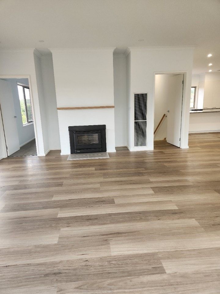 A Living Room With Hardwood Floors and a Fireplace — Evoke Building Group In Ballarat Central, VIC