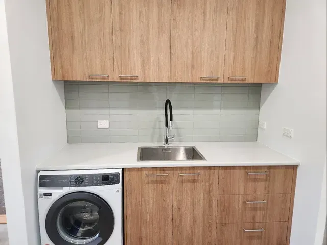 A Laundry Room With a Washer and Dryer and a Sink — Evoke Building Group In Ballarat Central, VIC