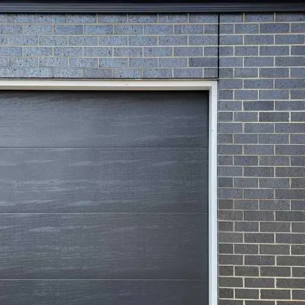 A Close Up of a Black Garage Door on a Brick Wall — Evoke Building Group In Ballarat Central, VIC