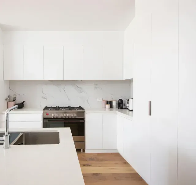 A Kitchen With White Cabinets, a Stove and a Sink — Evoke Building Group In Ballarat Central, VIC
