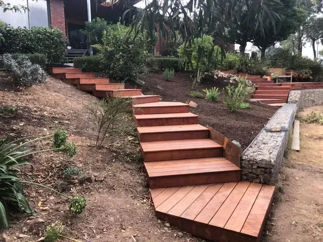 A Set of Wooden Stairs Leading Up to a House — Evoke Building Group In Ballarat Central, VIC