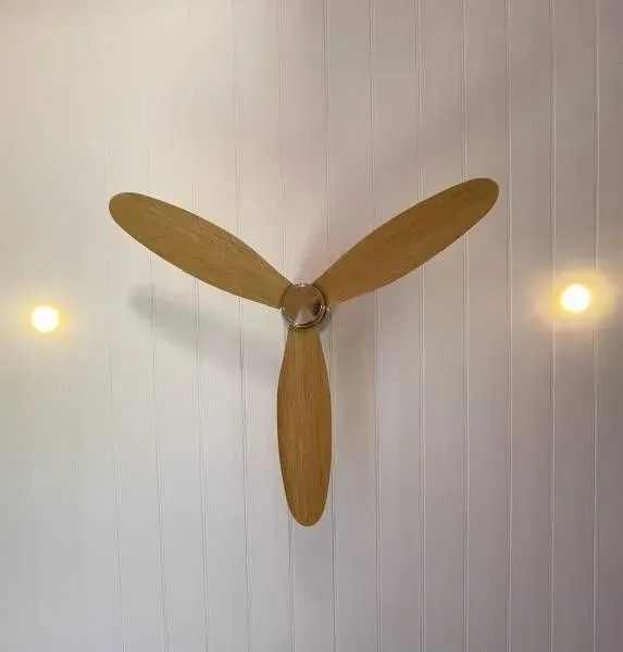 A Wooden Ceiling Fan is Hanging From the Ceiling in a Room — Evoke Building Group In Ballarat Central, VIC