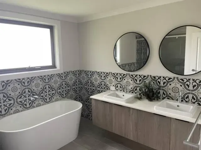 A Bathroom With Two Sinks , a Bathtub and Two Mirrors — Evoke Building Group In Ballarat Central, VIC