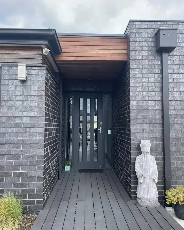 A Brick Building With a Statue in Front of It — Evoke Building Group In Ballarat Central, VIC