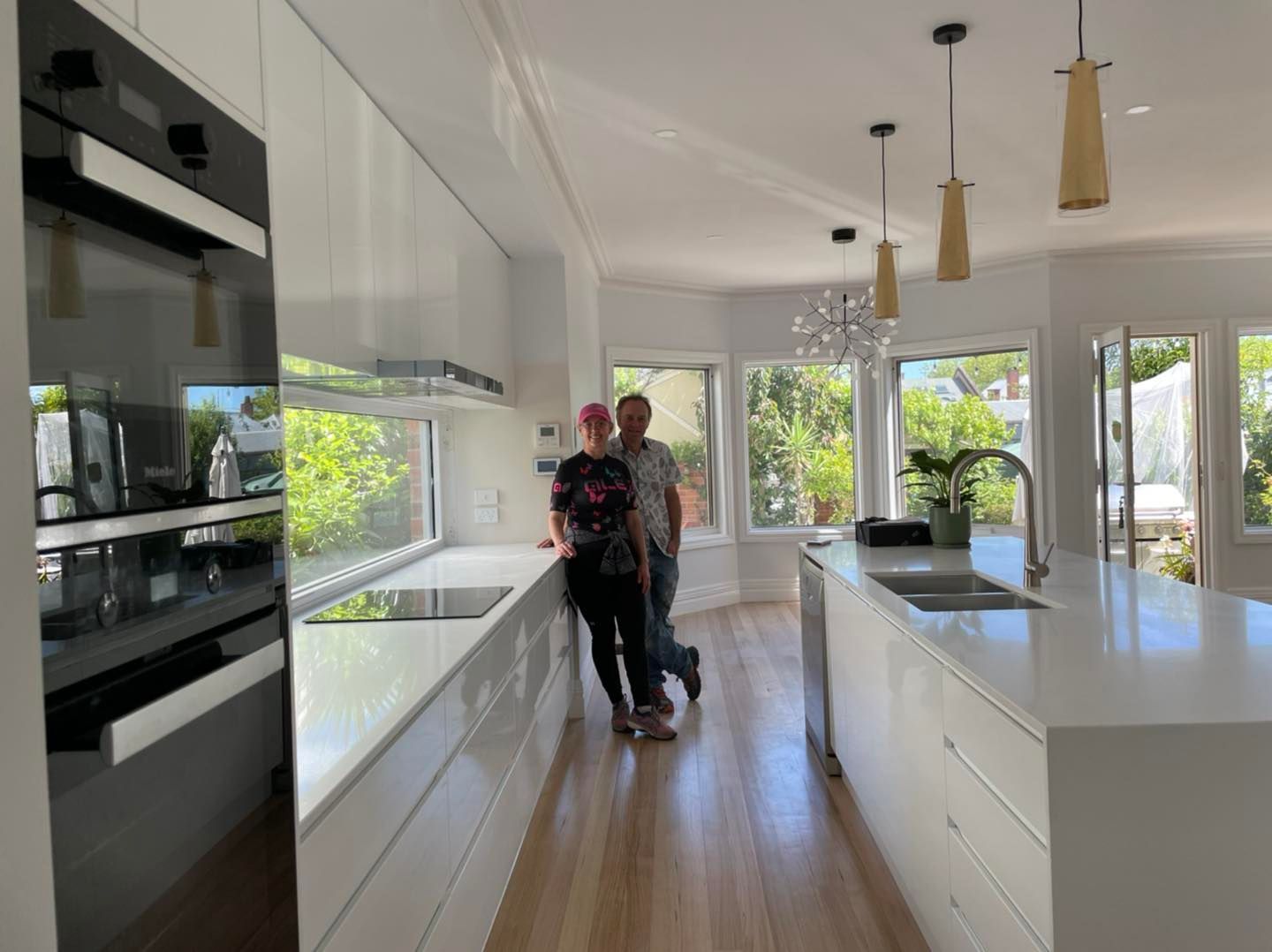 A Man and a Woman Are Standing in a Kitchen — Evoke Building Group In Daylesford, VIC