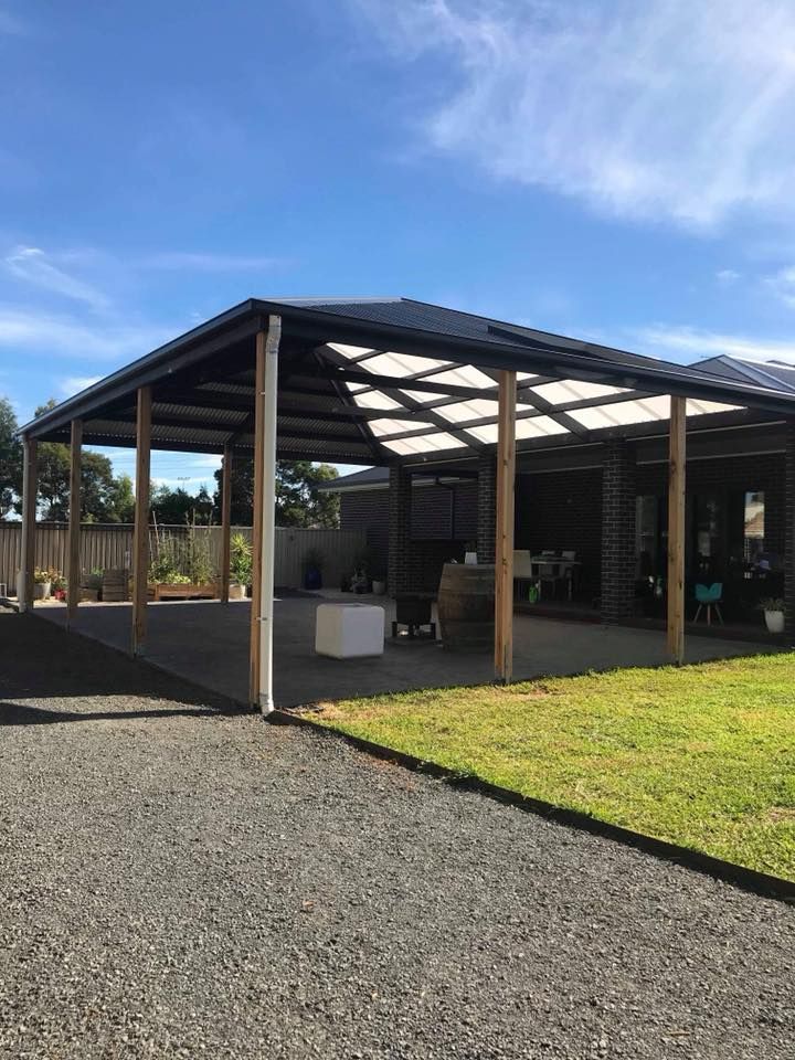 A Carport With a Roof That Has a Lot of Windows and a Driveway Leading to It — Evoke Building Group In Ballarat Central, VIC