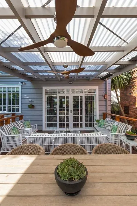 A Patio With a Table, Chairs, and a Ceiling Fan — Evoke Building Group In Bendigo, VIC