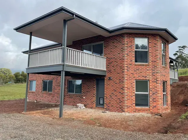 A Large Brick House With a Balcony and a Lot of Windows — Evoke Building Group In Ballarat Central, VIC