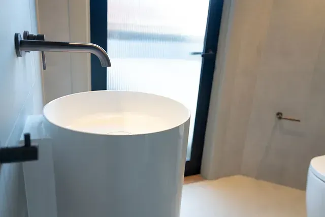 A Bathroom With a Sink,Toilet, and Window — Evoke Building Group In Ballarat Central, VIC