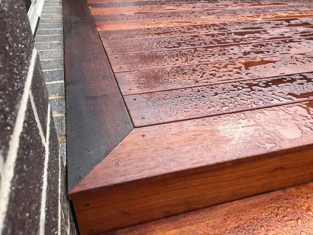 A Close Up of a Wooden Deck Next to a Brick Wall — Evoke Building Group In Ballarat Central, VIC