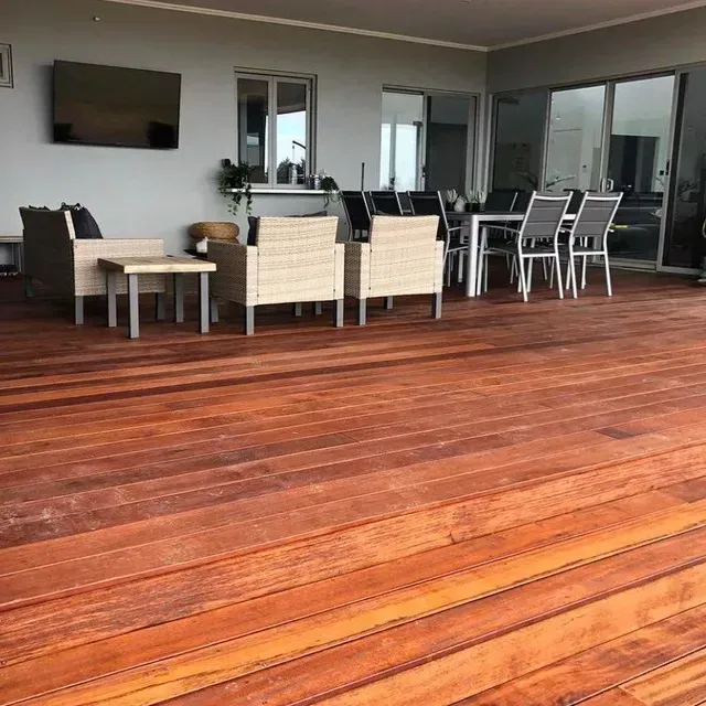 A Wooden Deck With a Dining Table and Chairs on It — Evoke Building Group In Ballarat Central, VIC