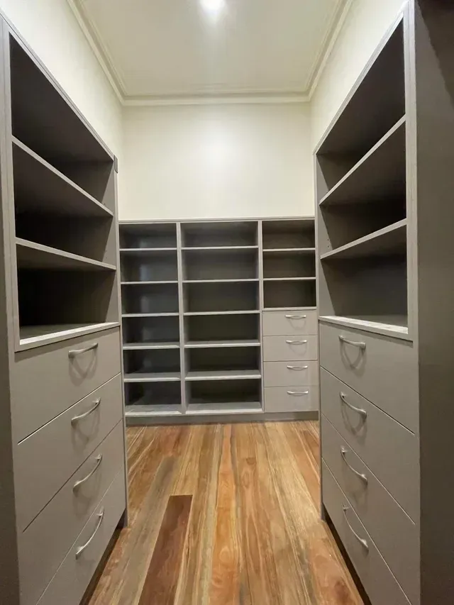 A Walk in Closet With Lots of Shelves and Drawers — Evoke Building Group In Bendigo, VIC