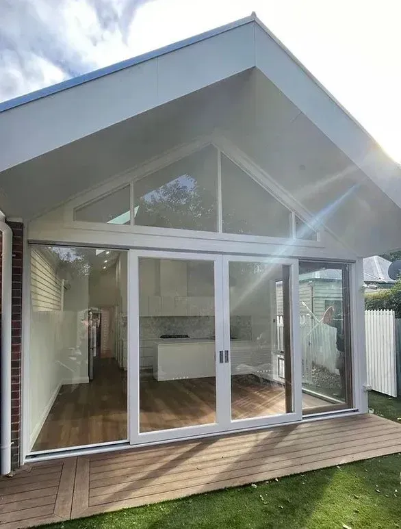 A White House With a Lot of Windows and Sliding Glass Doors — Evoke Building Group In Ballarat Central, VIC