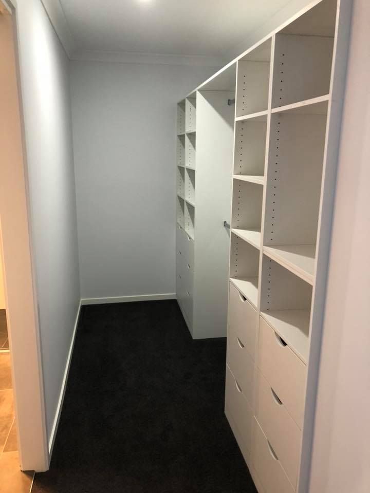 A Walk in Closet With Lots of Shelves and Drawers — Evoke Building Group In Ballarat Central, VIC