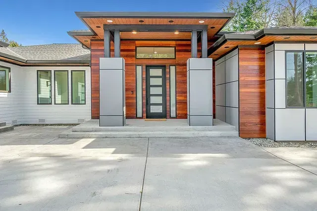 The Front of a Modern House With Wood Paneling and a Black Door — Evoke Building Group In Ballarat Central, VIC