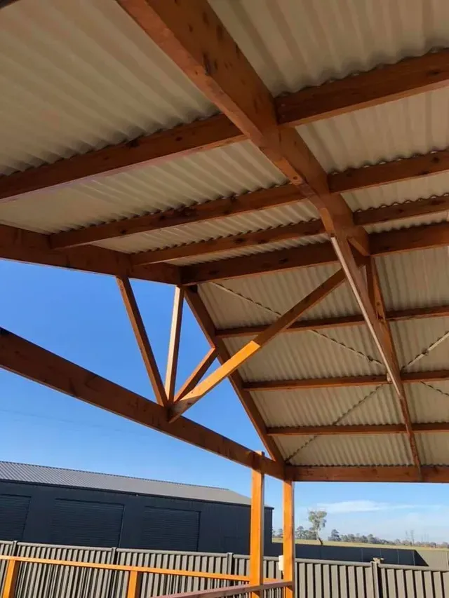 A Wooden Structure With a White Roof and a Blue Sky in the Background — Evoke Building Group In Ballarat, VIC