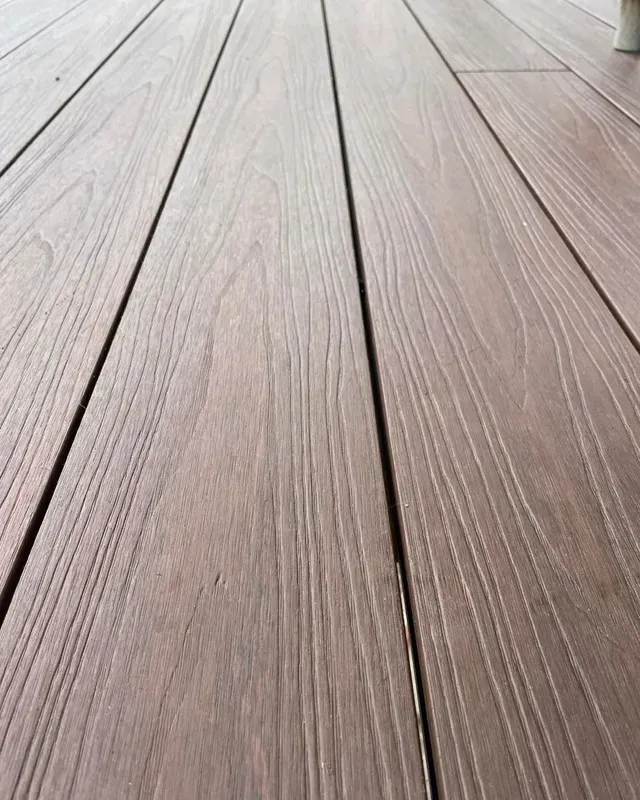 A Close Up of a Wooden Deck With a Chair in the Background — Evoke Building Group In Ballarat Central, VIC