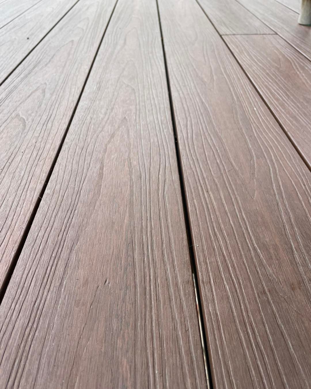 Brown composite deck boards with wood grain texture.
