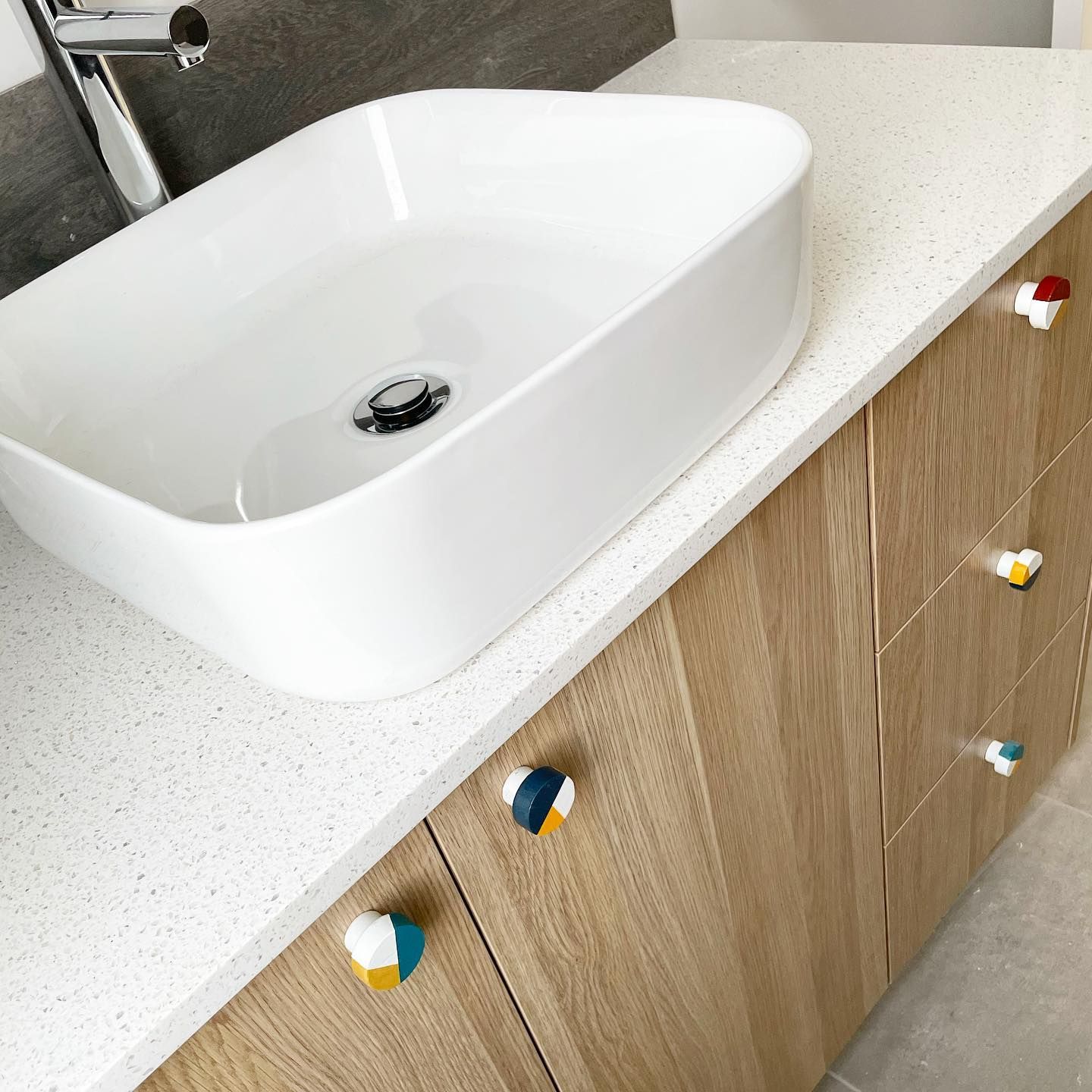 A White Sink is Sitting on Top of a Wooden Counter in a Bathroom — Evoke Building Group In Ballarat Central, VIC
