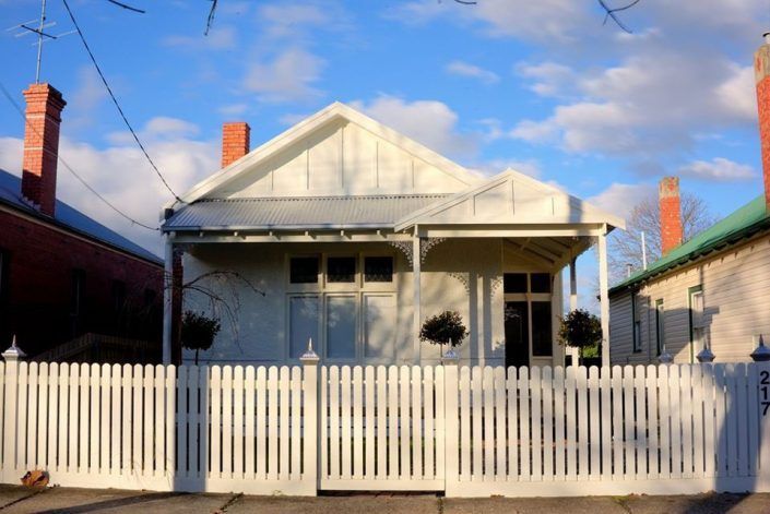 A Black House With a Wooden Deck in Front of It — Evoke Building Group In Ballarat Central, VIC