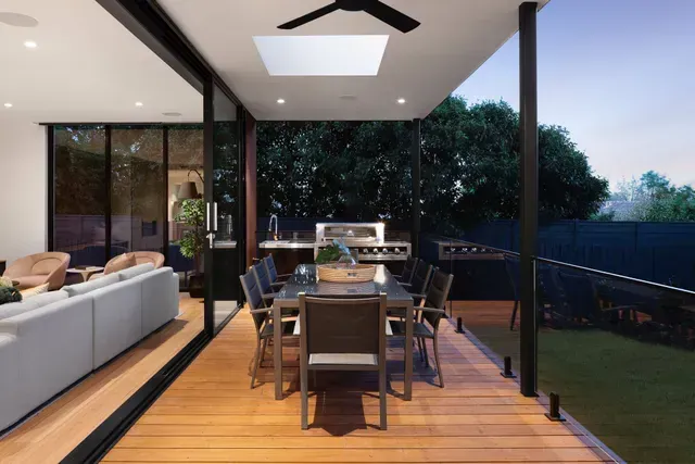 A Patio With a Table and Chairs and a Ceiling Fan — Evoke Building Group In Geelong, VIC