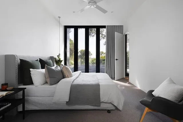 A Bedroom With a Large Bed and a Ceiling Fan — Evoke Building Group In Ballarat Central, VIC