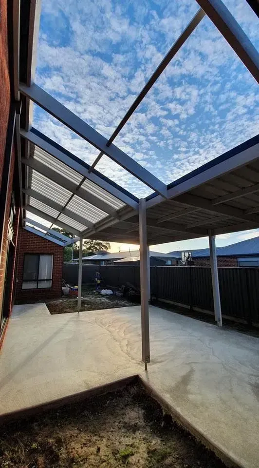 A Carport With a Clear Roof is in the Backyard of a House — Evoke Building Group In Bendigo, VIC