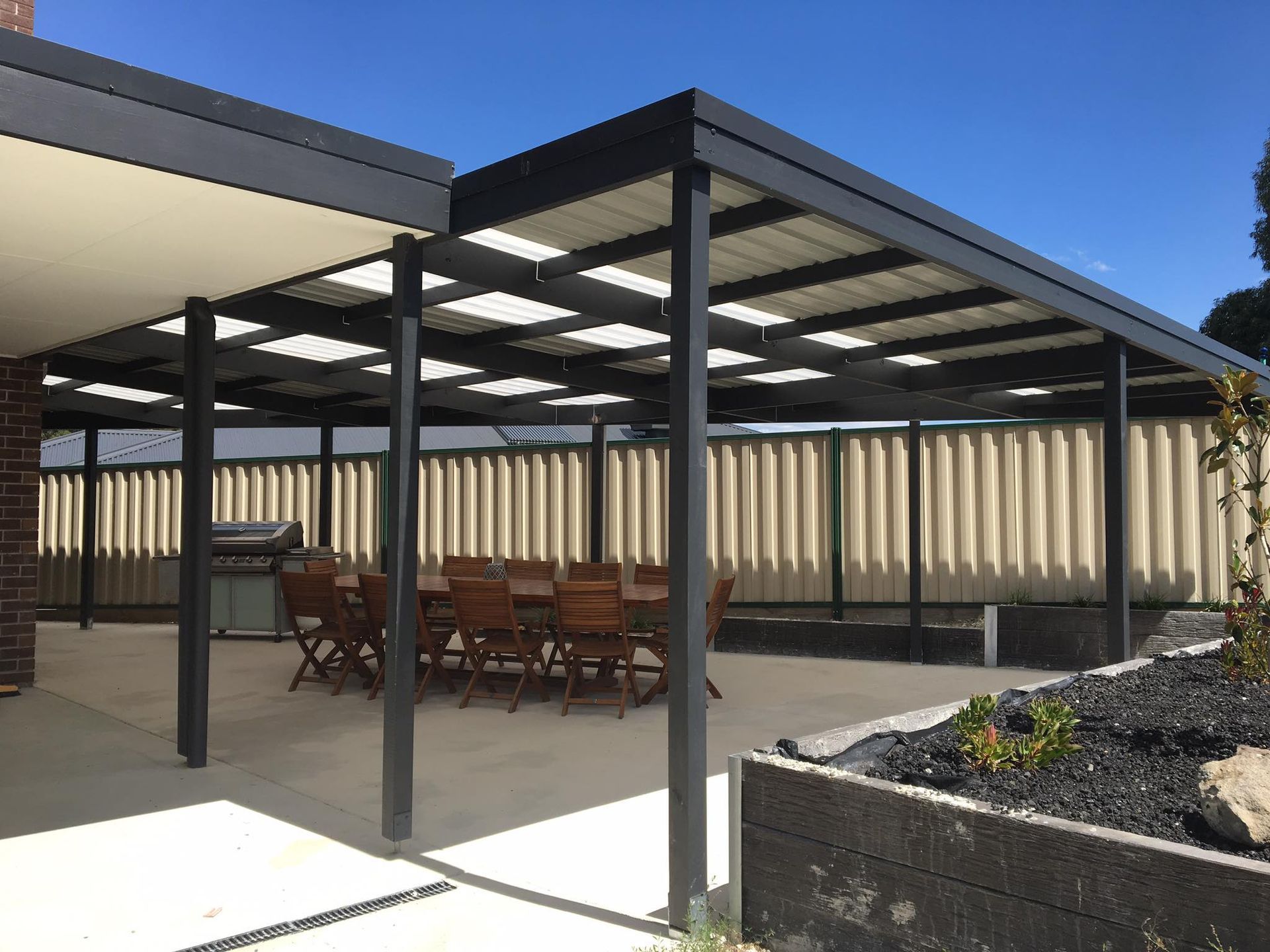 A Patio With a Table and Chairs Under a Pergola — Evoke Building Group In Ballarat Central, VIC