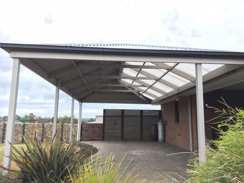 A Carport With a Clear Roof is in Front of a Brick House — Evoke Building Group In Ballarat Central, VIC