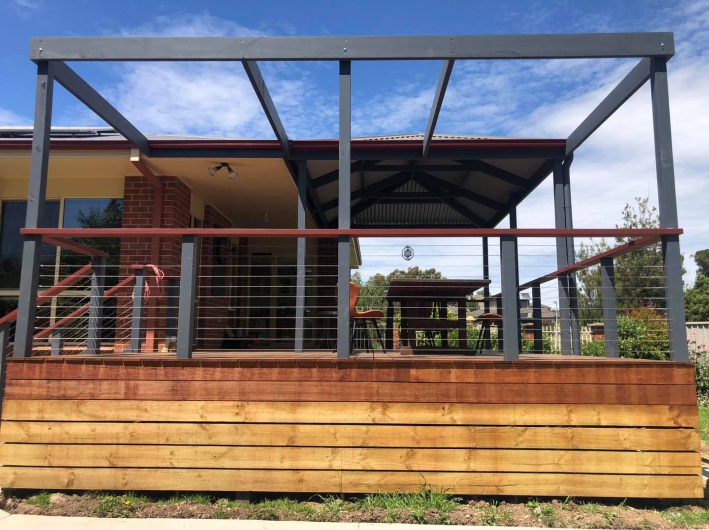 A Wooden Deck With a Pergola and a Table on It — Evoke Building Group In Ballarat Central, VIC