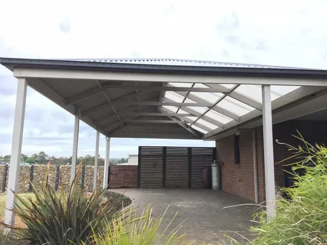 A Carport With a Clear Roof is in Front of a Brick House — Evoke Building Group In Ballarat, VIC