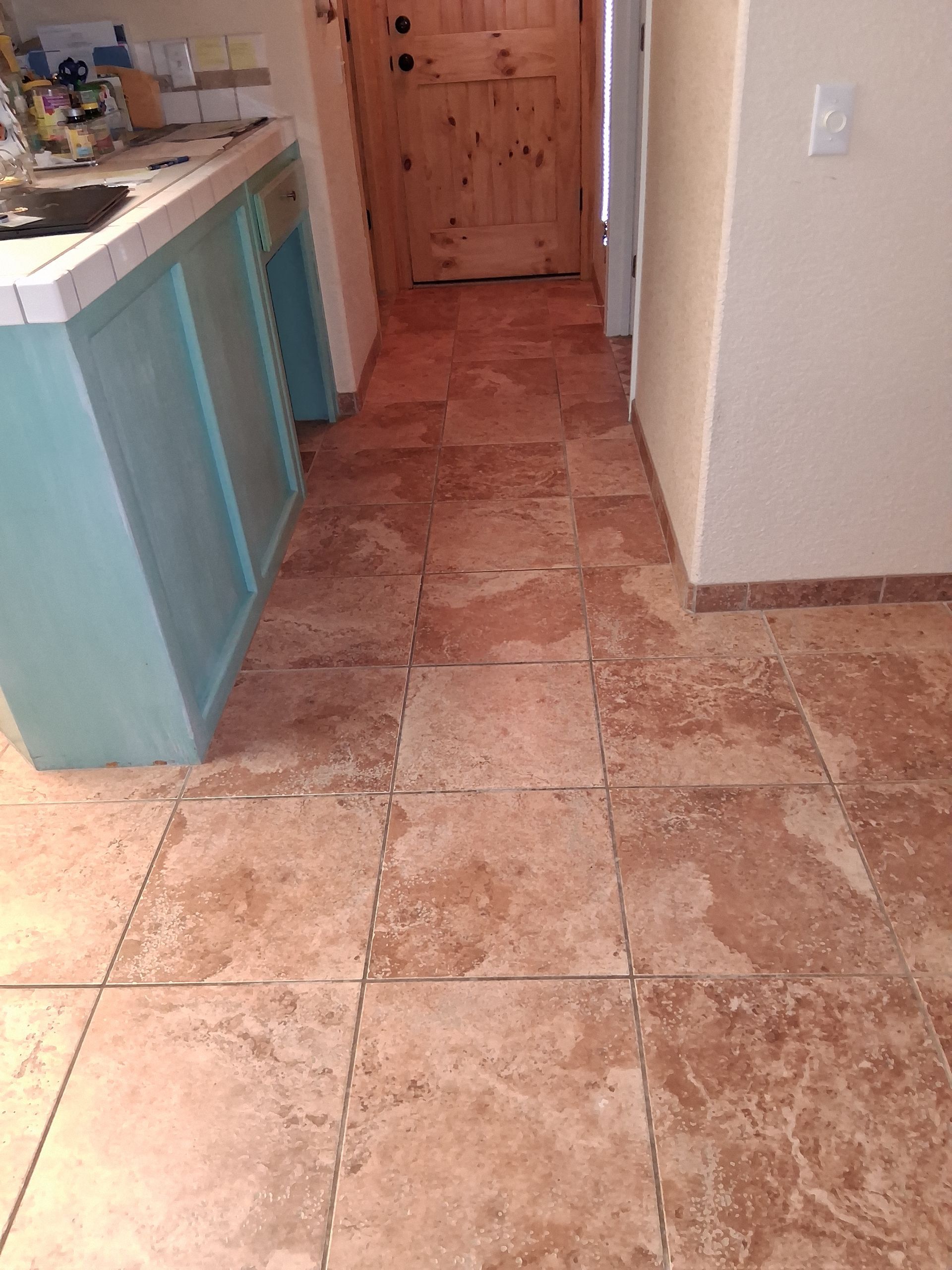 A close up of a tiled floor with a diagonal pattern