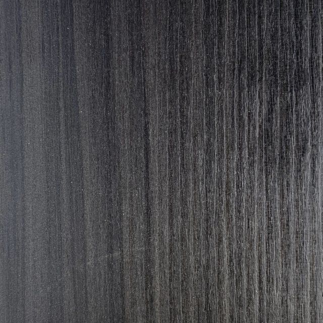 Deep dark wood grain texture of Havana Black Pine lightweight plywood for custom executive camper layouts.