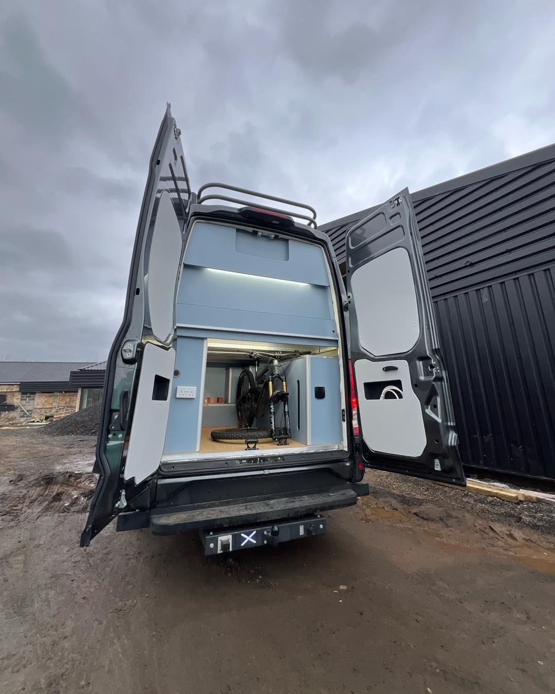 Open van with rear doors open, showing storage interior