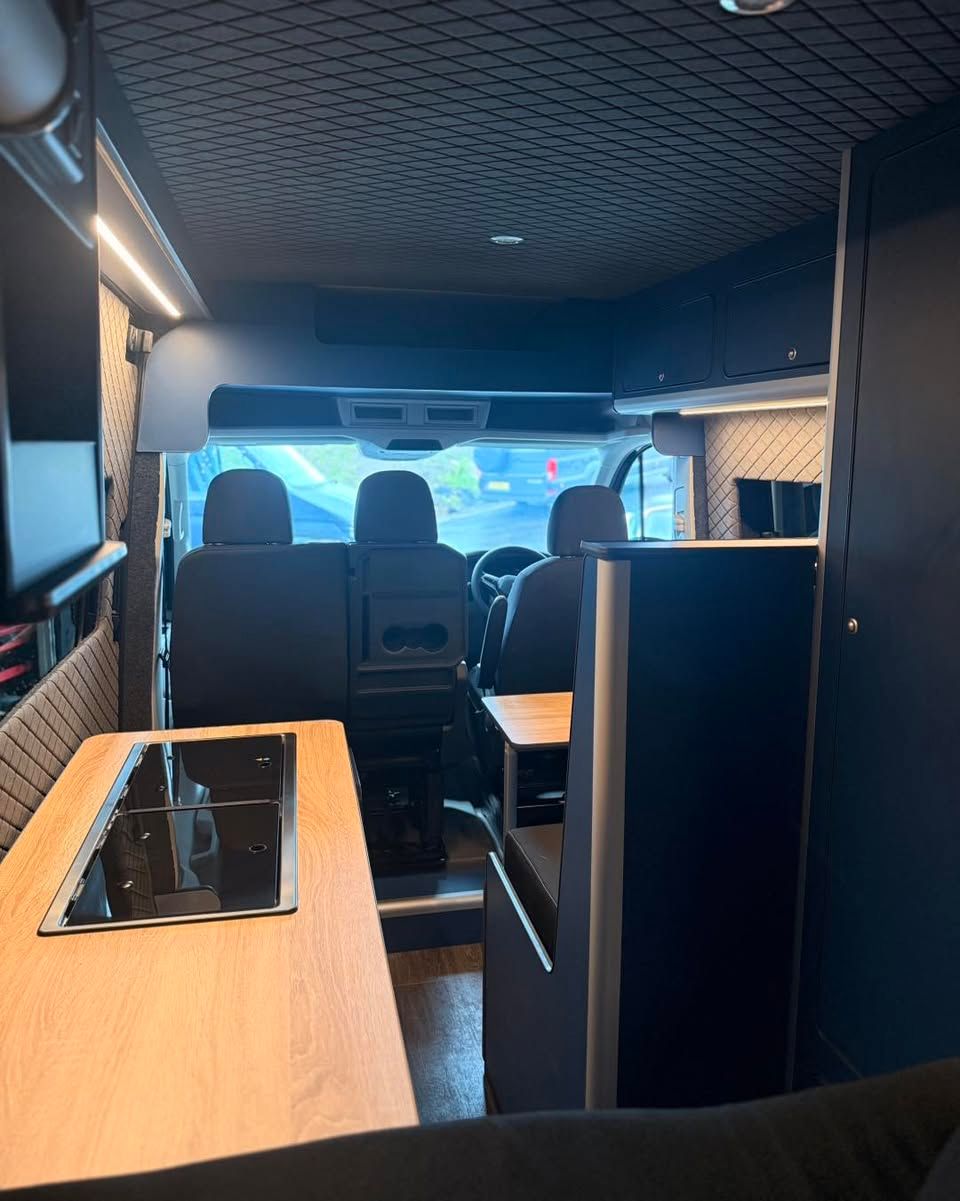 Custom electric blue VW Crafter campervan conversion interior featuring Scot Seat bed setup