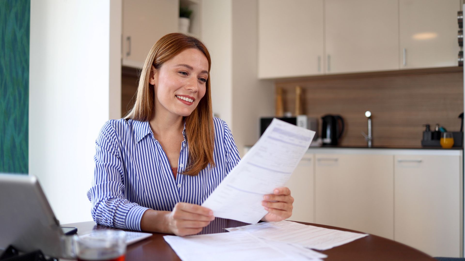 A woman is reviewing some insurance papers for her business.