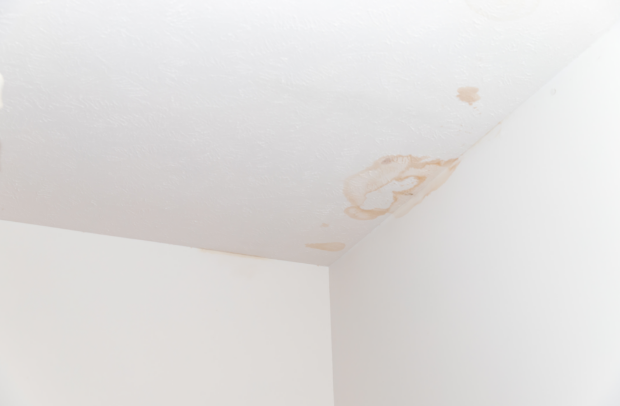 There is a stain on the ceiling of a room.