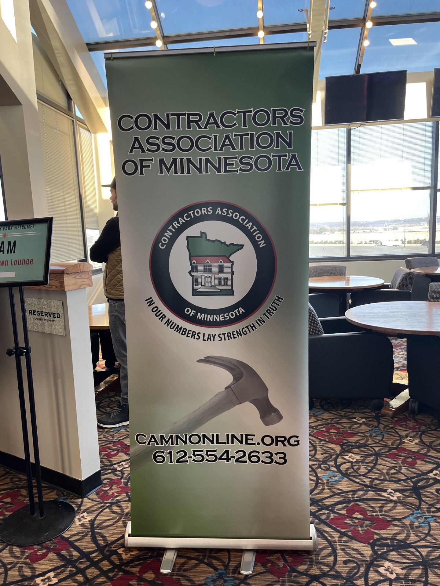 Roll-up banner for the Contractors Association of Minnesota with logo and contact information.