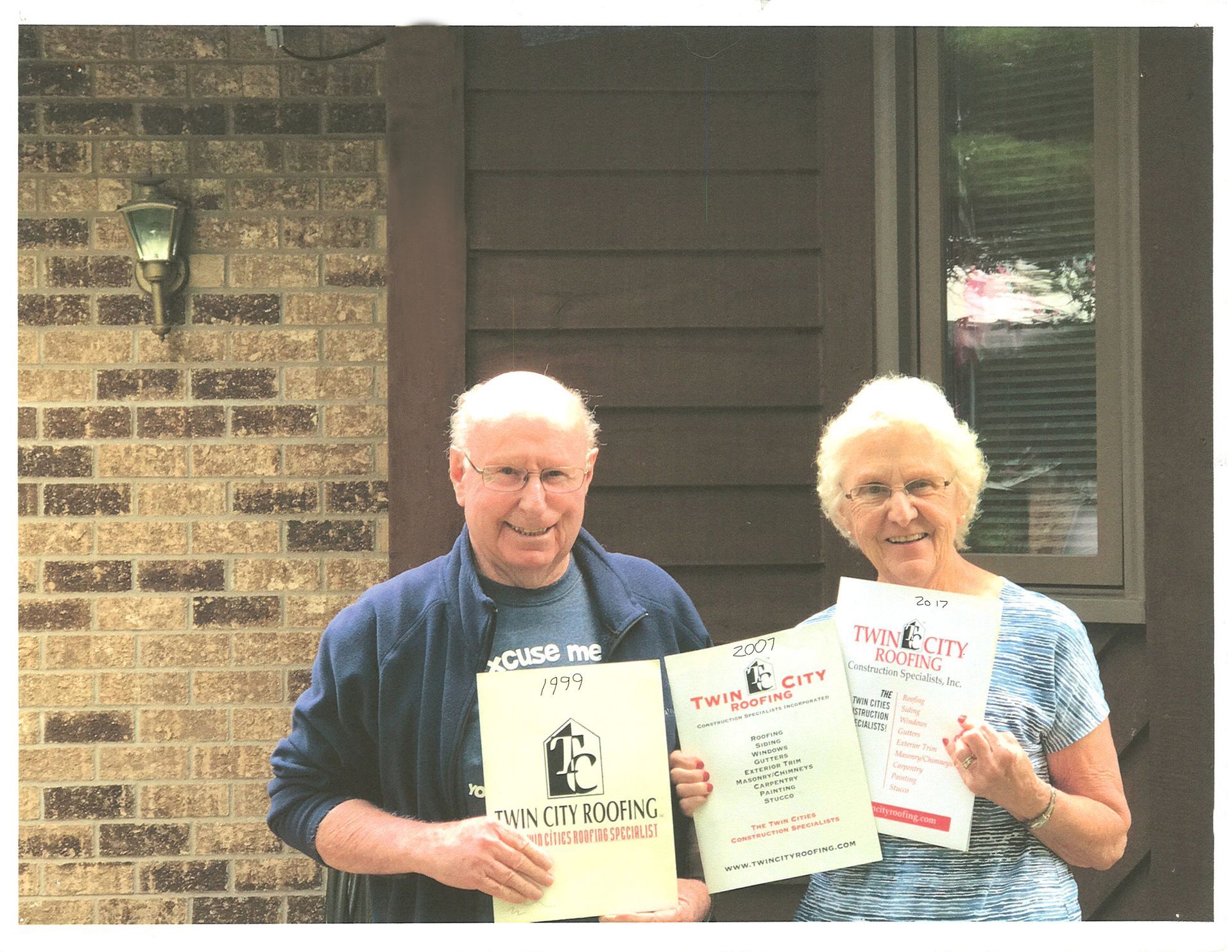 A man and a woman are holding a sign that says e on it