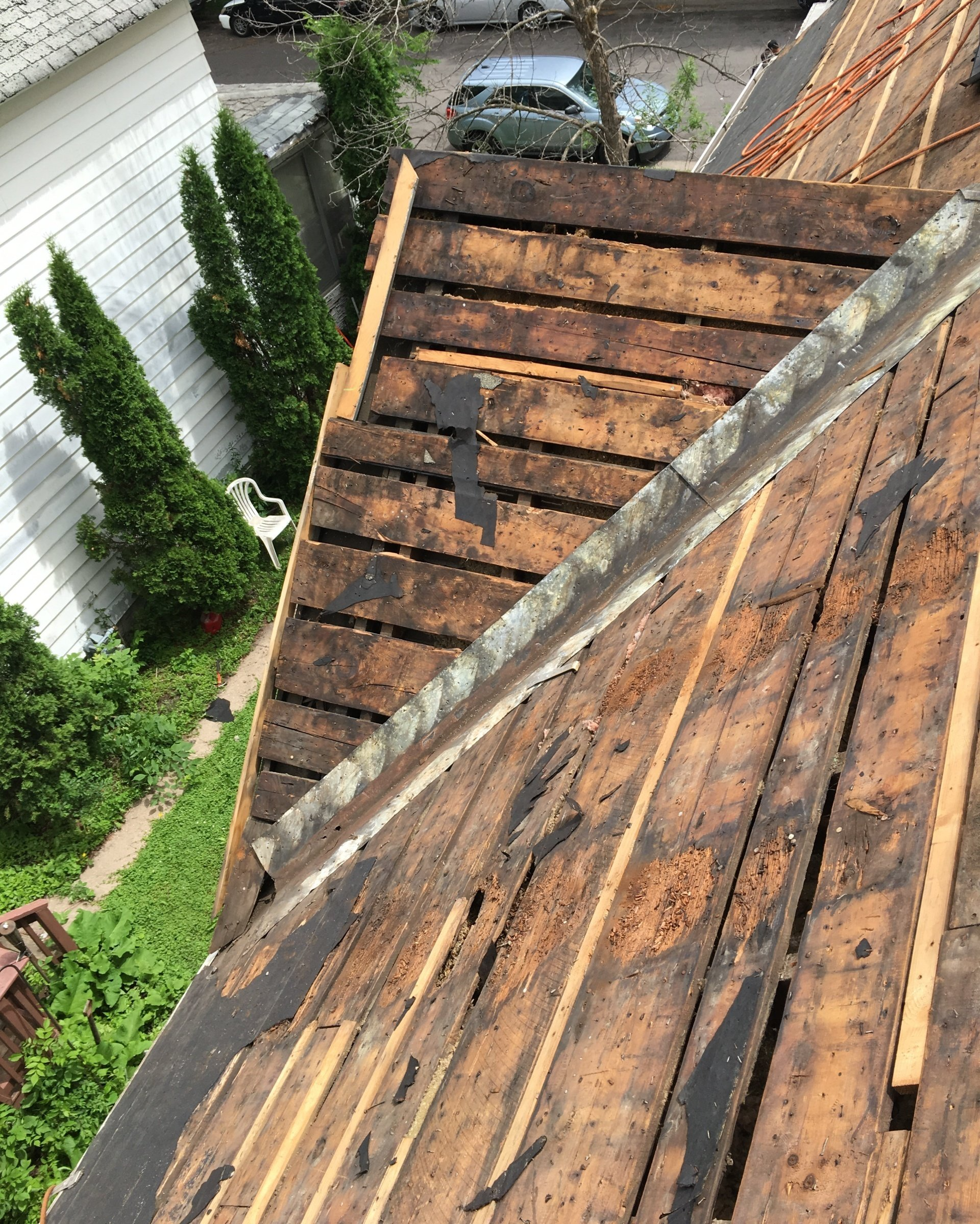 A wooden roof is being removed from a house.