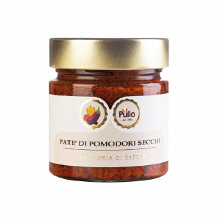 Vasetto di paté di pomodori secchi Pillo con coperchio dorato ed etichetta bianca su sfondo bianco.