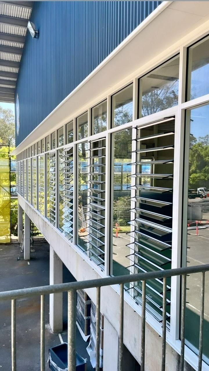 A Building With a Lot of Windows and Shutters on It — Architectural Glass Solutions QLD in Cooroy, QLD