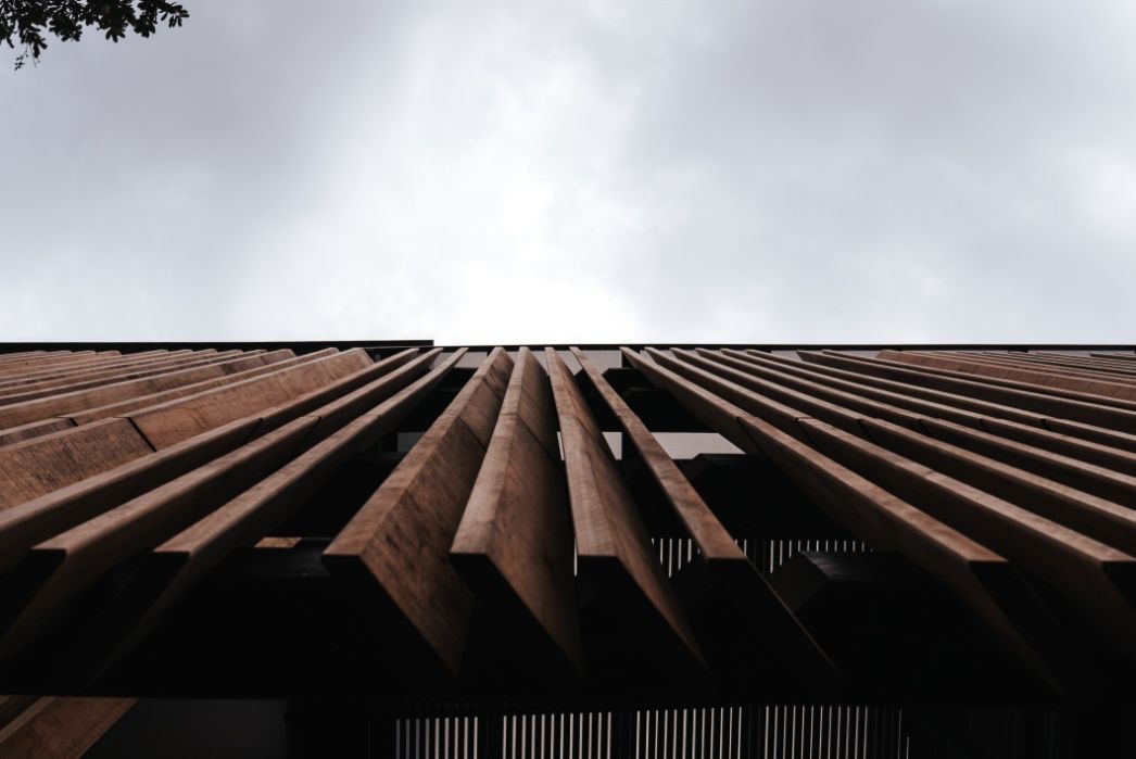 Looking Up at a Wooden Building With a Cloudy Sky in the Background — Architectural Glass Solutions QLD in Cooroy, QLD