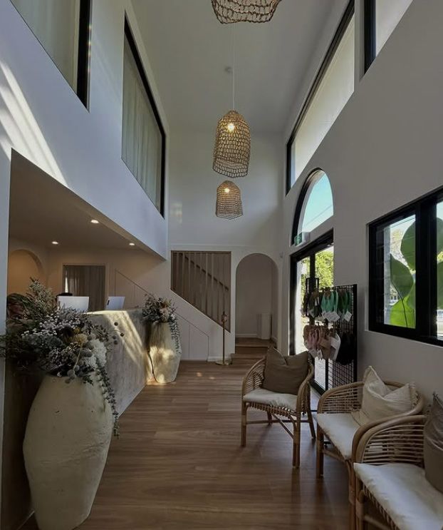 Bright, Airy Lobby With Wood Floors, White Walls & Rattan Furniture — Architectural Glass Solutions QLD in Cooroy, QLD