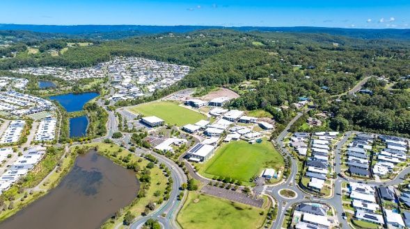 An Aerial View of a Residential Area Surrounded by Trees and a Lake — Architectural Glass Solutions QLD in Cooroy, QLD