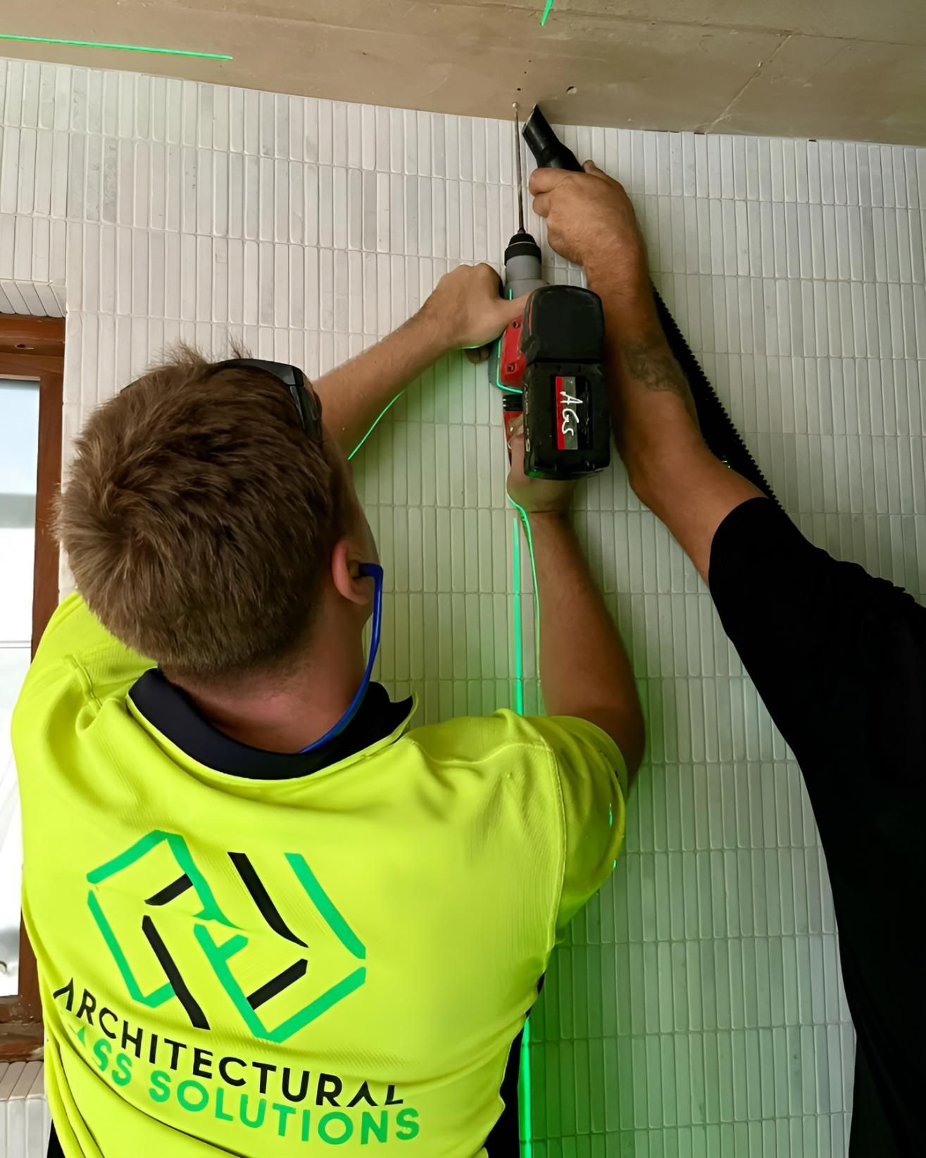 Two tradies drilling into the ceiling— Architectural Glass Solutions QLD in Cooroy, QLD