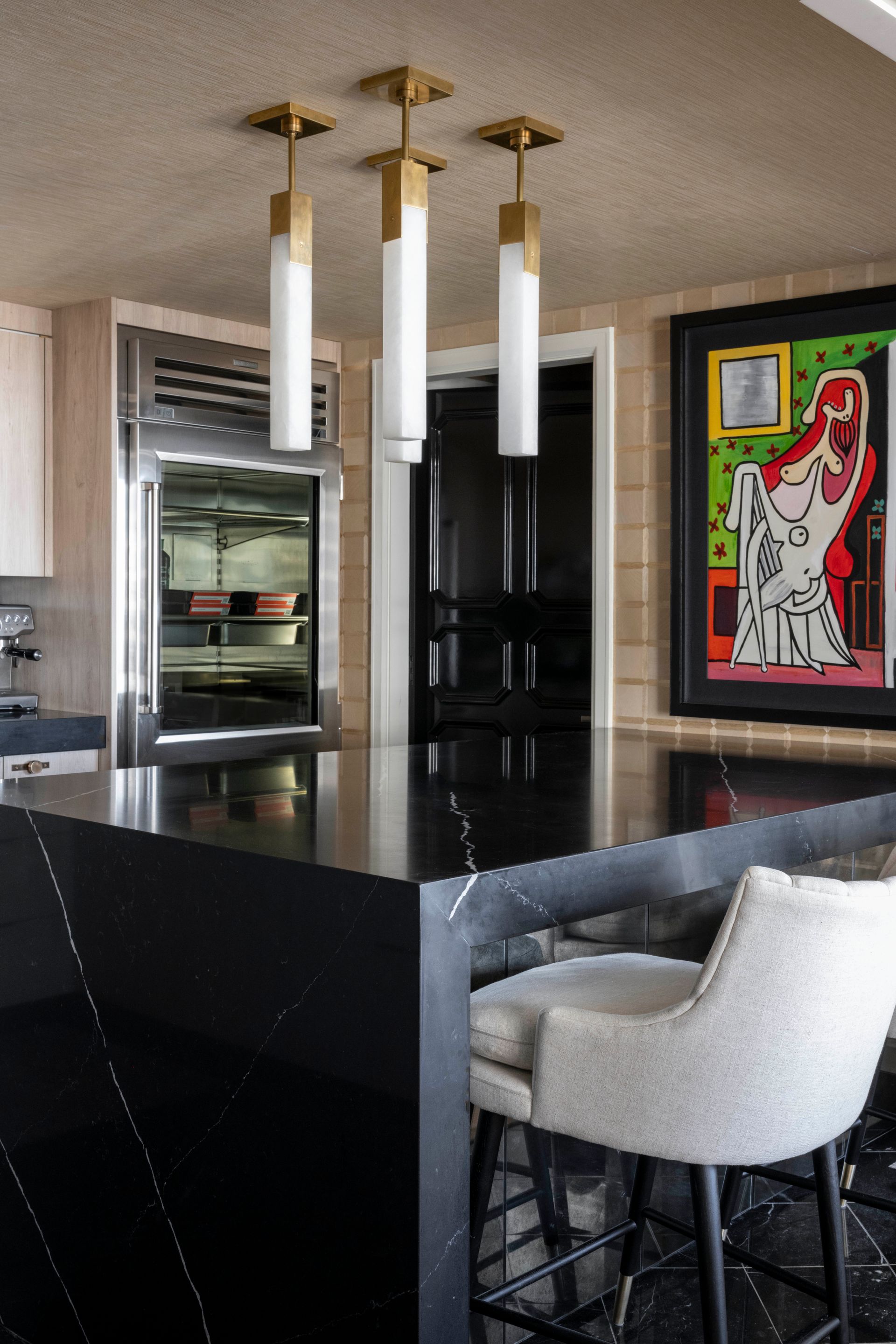 A kitchen with a painting of a woman on the wall